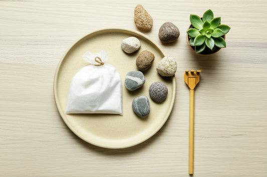 A diy zen garden kit laid out on a plate. All the basic mini zen garden materials you need.