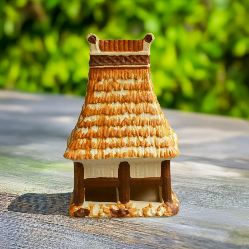 This intricately crafted miniature Rong house, with its rustic ceramic finish and traditional design, brings a touch of Vietnamese culture to any shelf or tabletop.