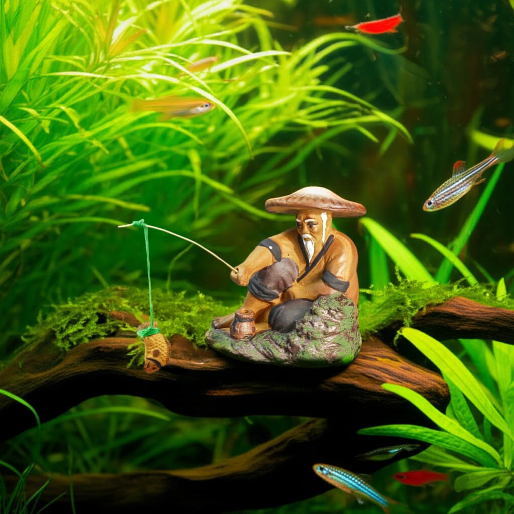 Close-up of a fishing figurine, perfect ceramic aquarium decor, on driftwood among plants