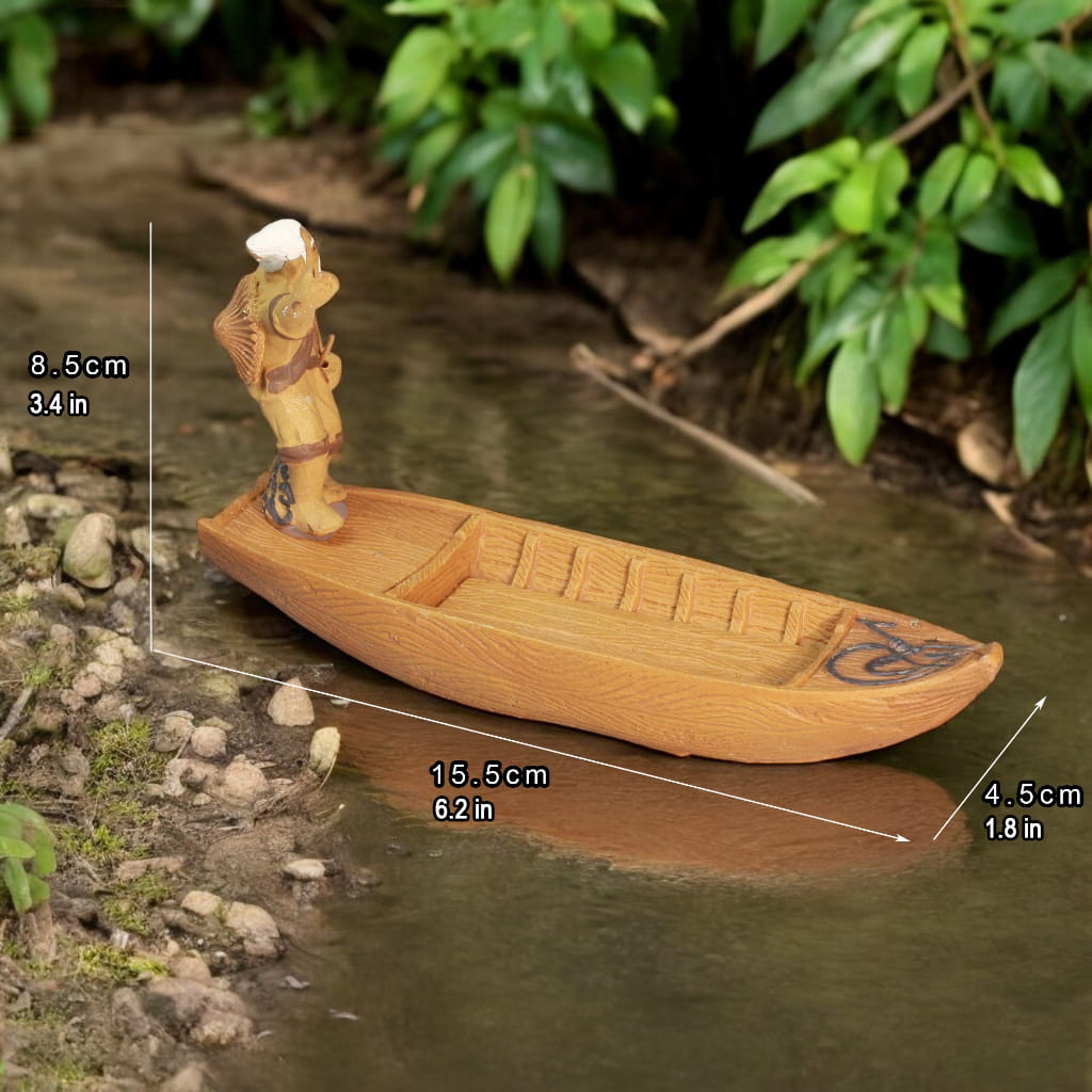 A ceramic figurine of an old fisherman rowing a wooden boat on a river.