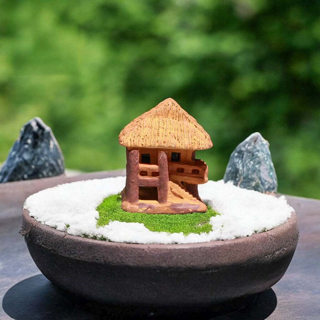 Brown fairy house figurine, this miniature stilt house figurine, on green moss in bonsai pot.