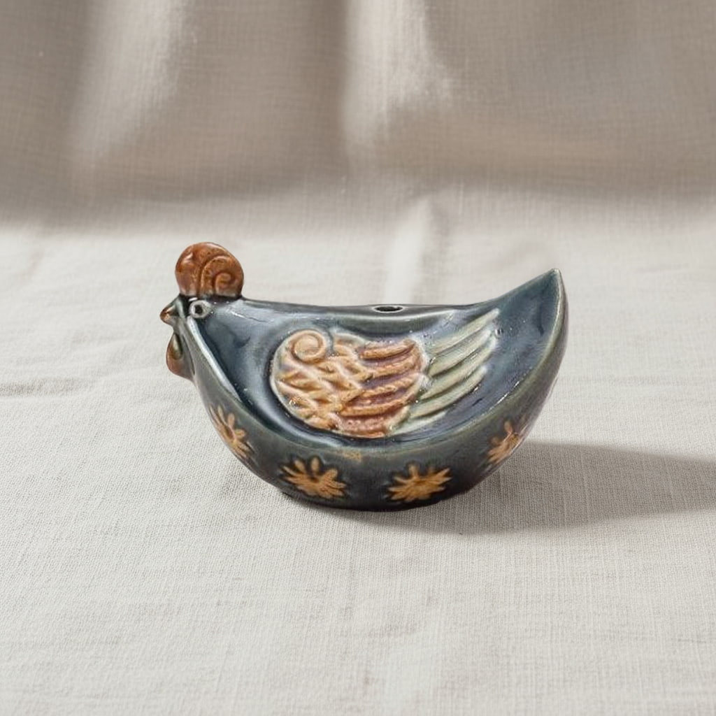 A blue-grey hand-painted rooster ceramic. A classic piece of farmhouse kitchen rooster decor.