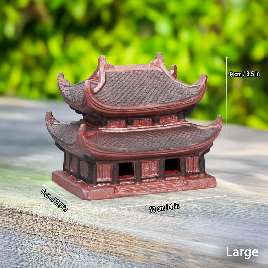 Large size miniature pagoda statue. The reddish-brown Vietnamese pagoda on a wood surface.