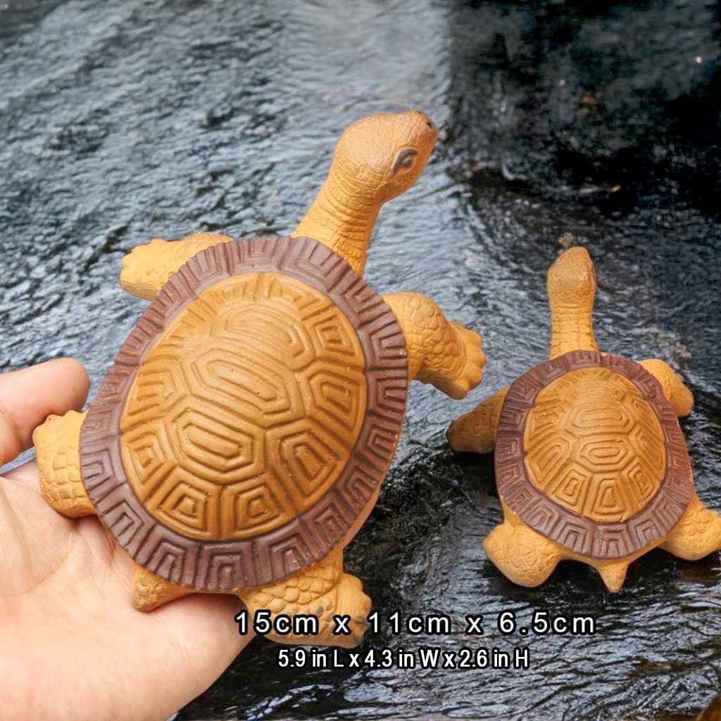 Hand holds a large turtle statue, 15cm, yellow and brown. Great as turtle decor for tank.