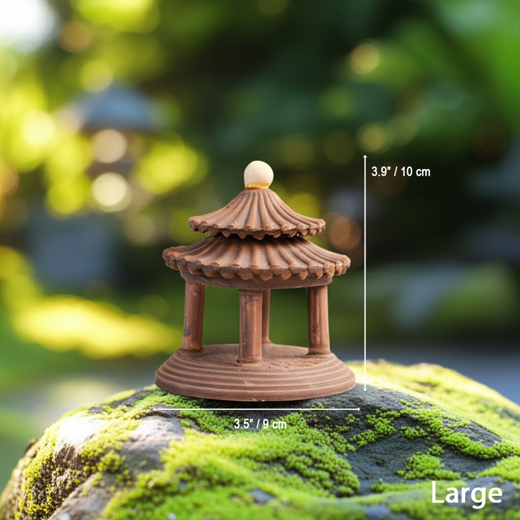 The large pagoda statue on a mossy rock. This Japanese pagoda miniature is 10cm tall.
