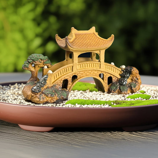This miniature bridge for garden also works as a fairy bridge, sitting on white pebbles and moss.