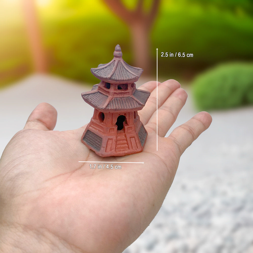 Hand holding small round miniature pagoda for bonsai. One of our bonsai figurines.