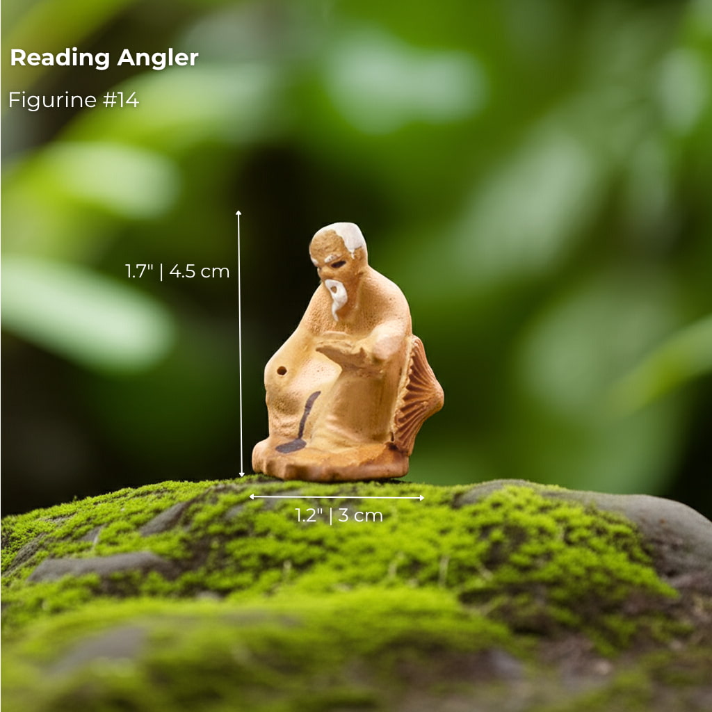 A Reading Angler, a unique mudmen figurine. A thoughtful addition to your bonsai decor.