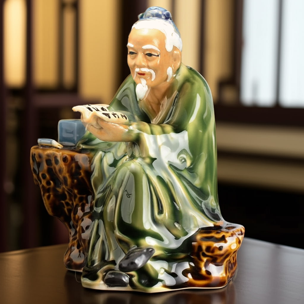 A classic bonsai mudmen figurine of a scholar reading. One of many detailed mudmen figurines.