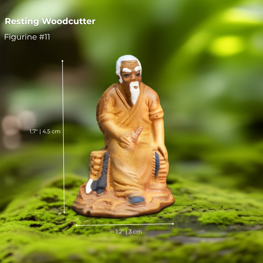 A Resting Woodcutter mudmen figurine on green moss. A classic piece of bonsai decor.