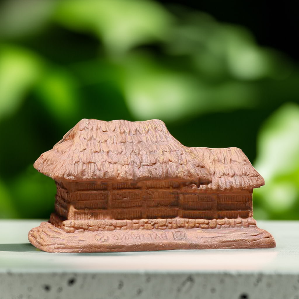 A brown thatched house figurine seen from the side, with a textured roof and simple walls. This mini house figurines is compact.