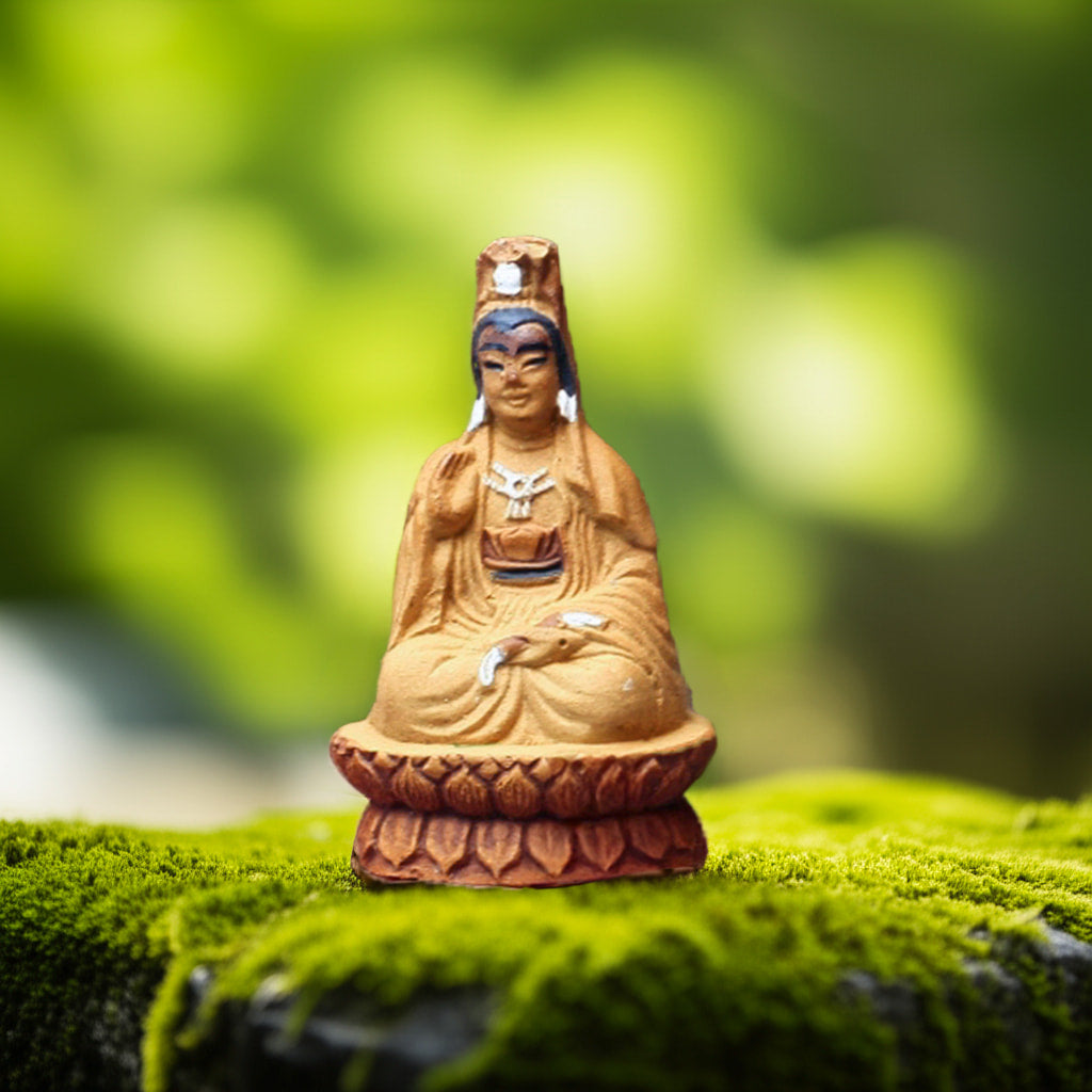 A seated Guanyin bonsai figurines on a lotus base. One of the many unique bonsai mudmen we offer.
