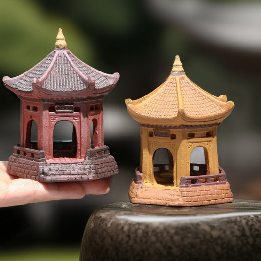 Two miniature pagoda statues, one yellow and one red, side-by-side. Great bonsai decoration.