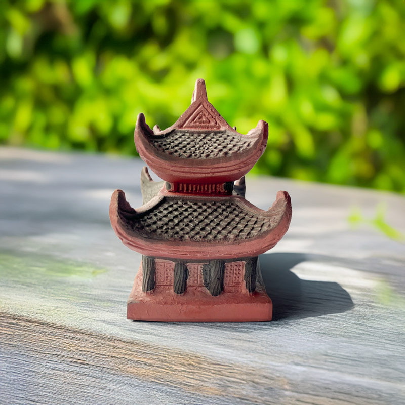 Side view of the Vietnam pagoda statue. Shows the two-tiered ceramic pagoda design clearly.