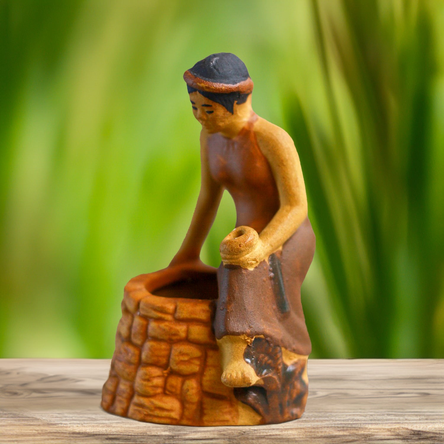 Hand-painted with delicate details, this charming Tam figurine, perched on a rustic well, brings a touch of Vietnamese folklore to any bonsai or aquarium.