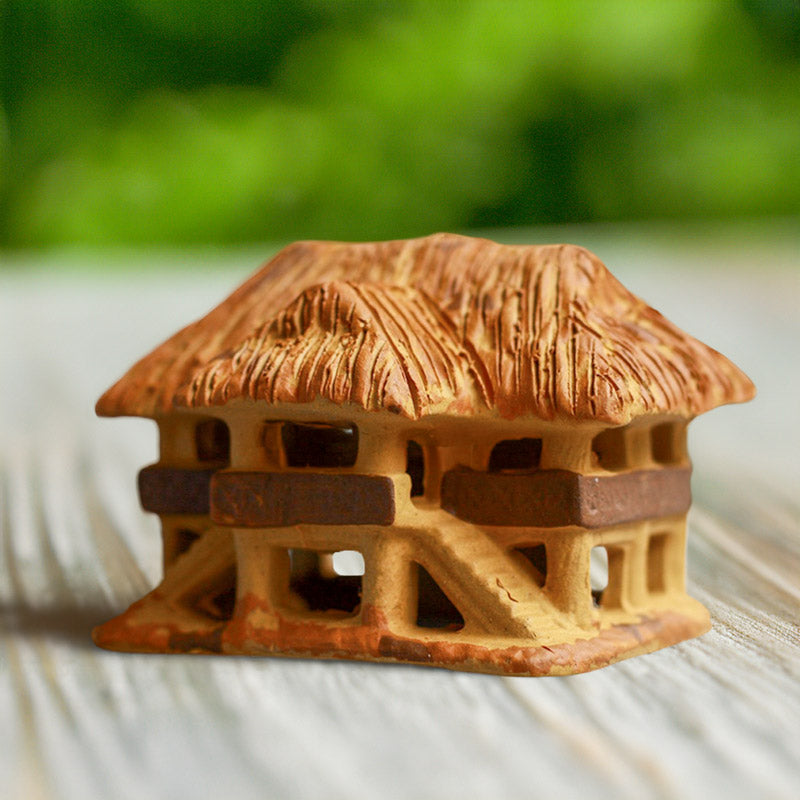This miniature ceramic stilt house, meticulously crafted with intricate details, evokes the traditional architecture of Vietnam, making it a unique and thoughtful gift.