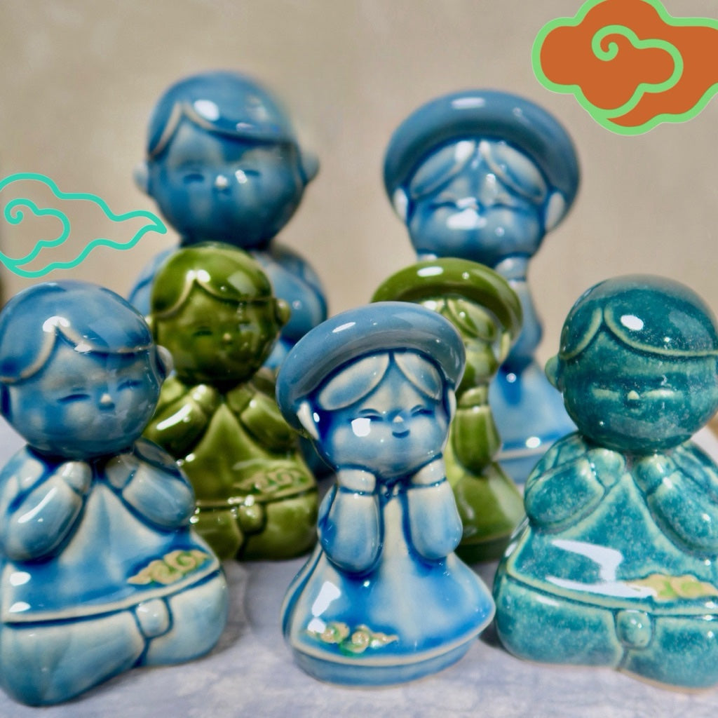 Blue Vietnamese ceramic children figurines with decorative cloud graphics
