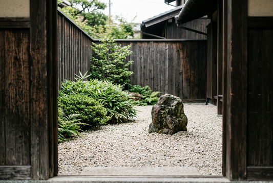 Small Japanese-inspired courtyard with one feature stone and open gravel.
