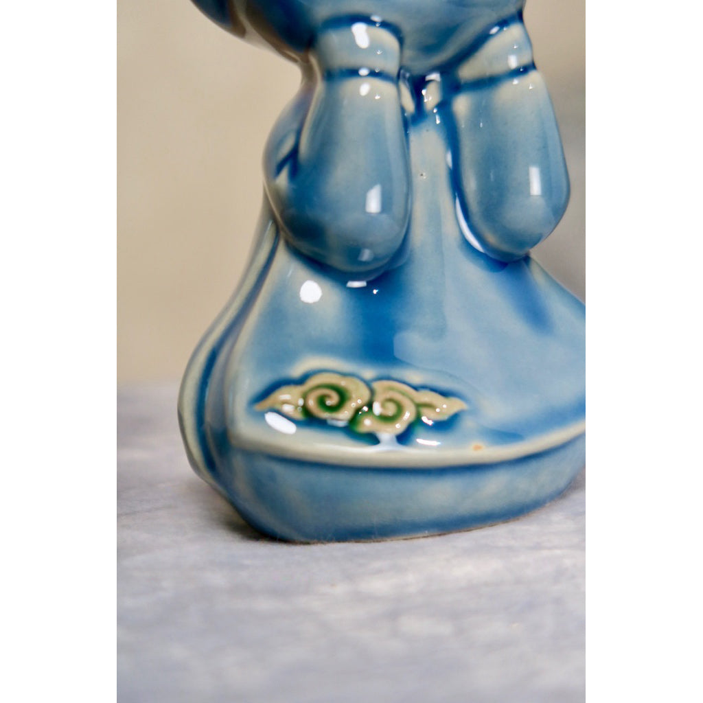 Detail of the cloud motif on a blue Vietnamese ceramic boy figurine