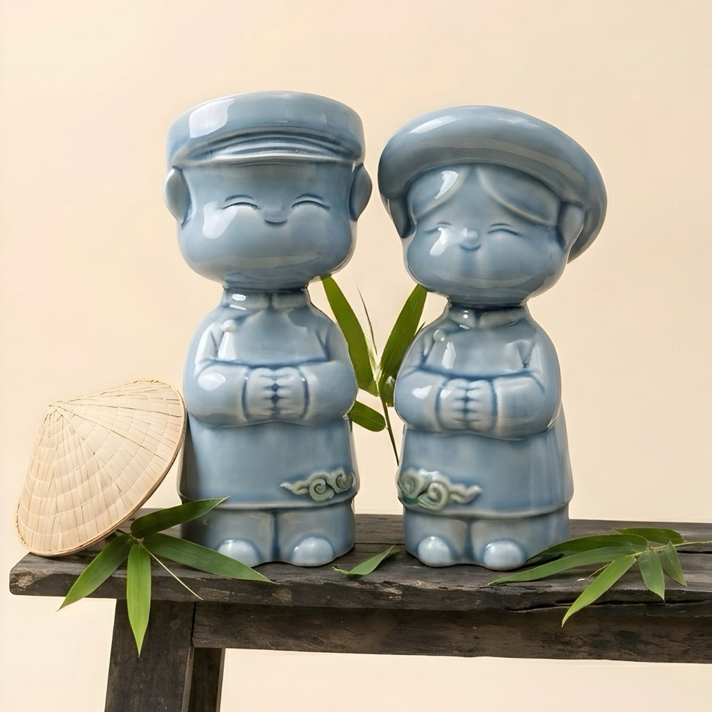 Blue-glazed Vietnamese ao dai children couple figurines displayed with a conical hat