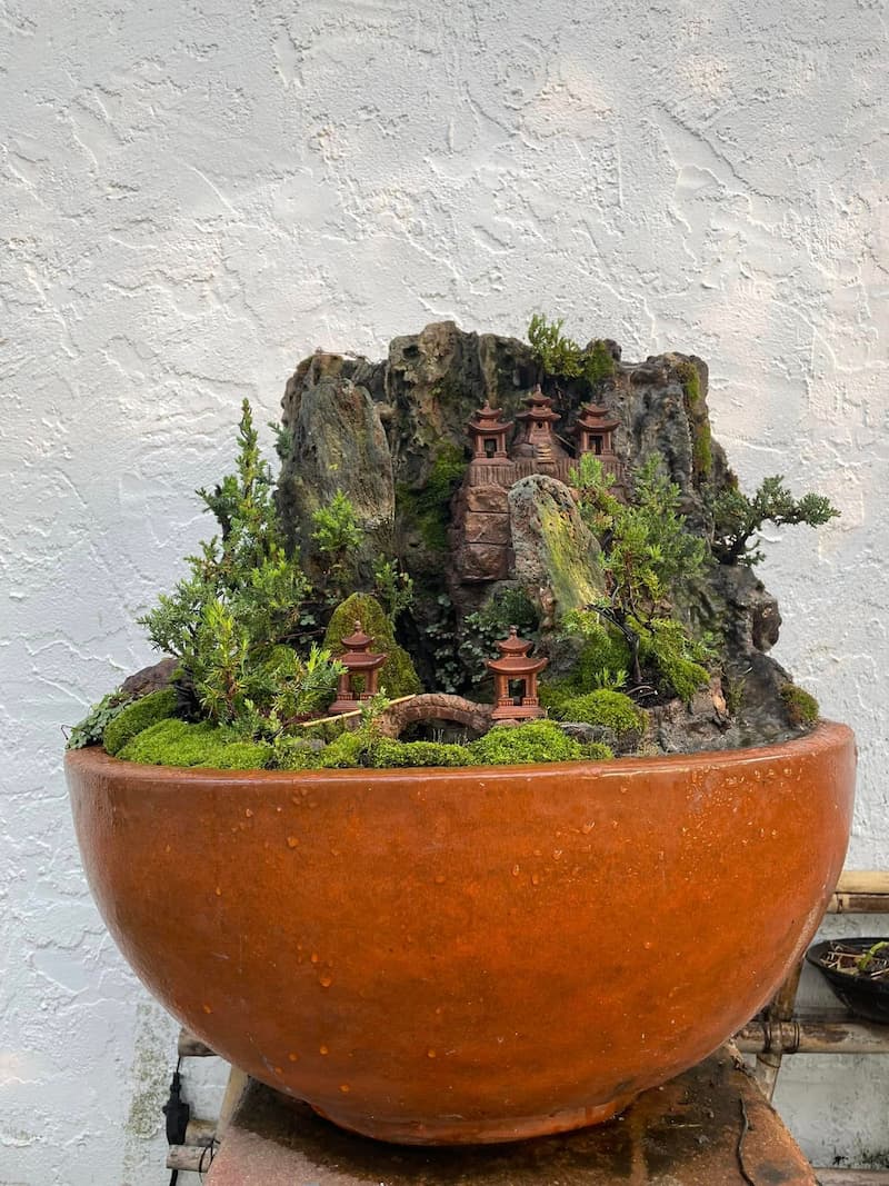 Customer bonsai project using miniature ceramic scene pieces.
