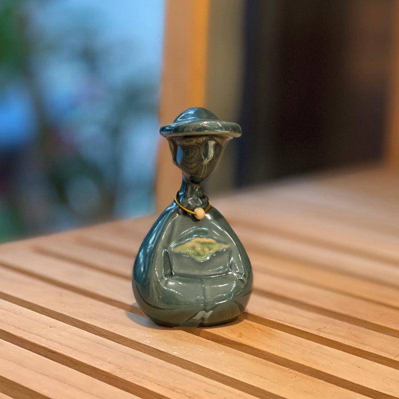 Close-up of a small duck-green Vietnamese woman ceramic figurine
