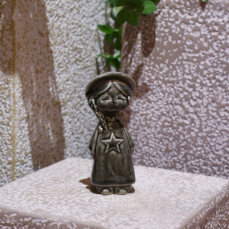 Charcoal-gray Vietnamese ceramic star child figurine