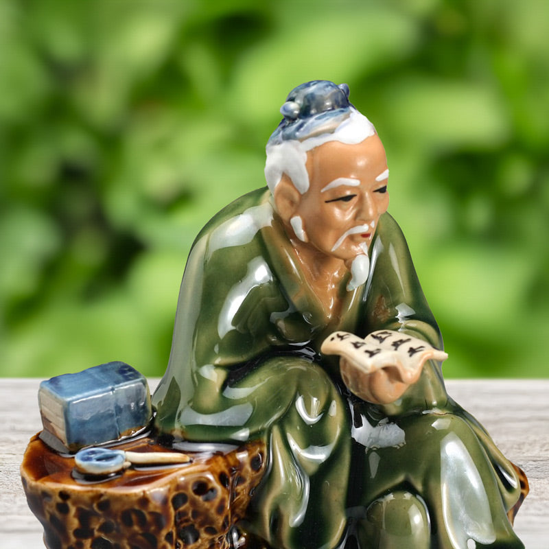 Handcrafted from Bat Trang ceramic, this miniature scholar figurine captures the essence of quiet contemplation, his weathered face etched with years of wisdom and knowledge.