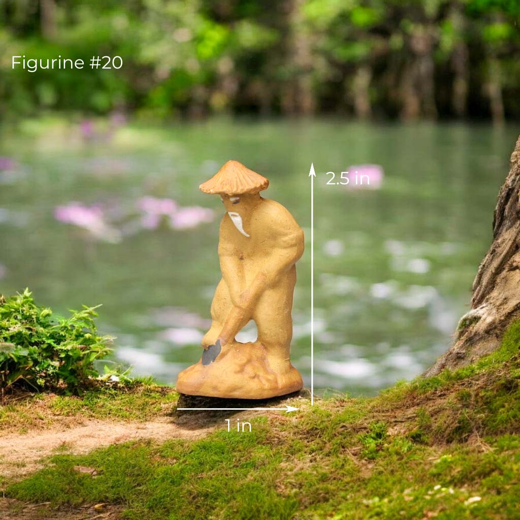 Small clay figurine of a farmer wearing a conical hat, using a hoe.