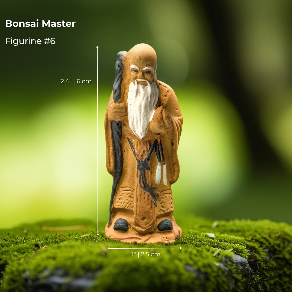A "Bonsai Master" bonsai mudmen figure on moss. A detailed mudmen figurine for bonsai decor.
