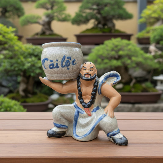 A close-up of the bonsai statue pot, a figurine bonsai planter with crackle glaze.