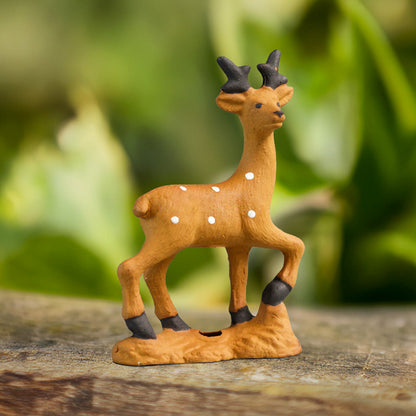  A charming miniature deer figurine, crafted from authentic Bat Trang ceramics, stands gracefully amidst a lush green backdrop, adding a touch of whimsy to any miniature landscape.