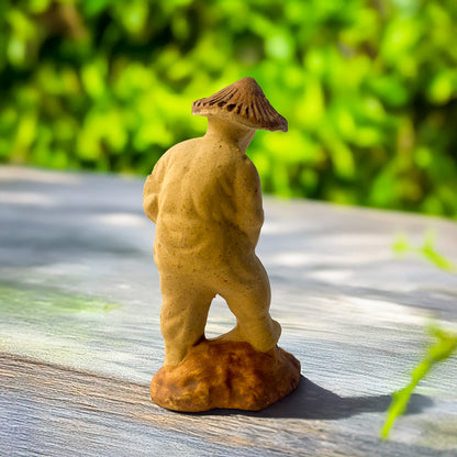 This charming miniature gardener, hand-sculpted from natural clay, wears a traditional conical hat as he tends to his miniature landscape, bringing a touch of Vietnamese culture to your bonsai or terrarium.