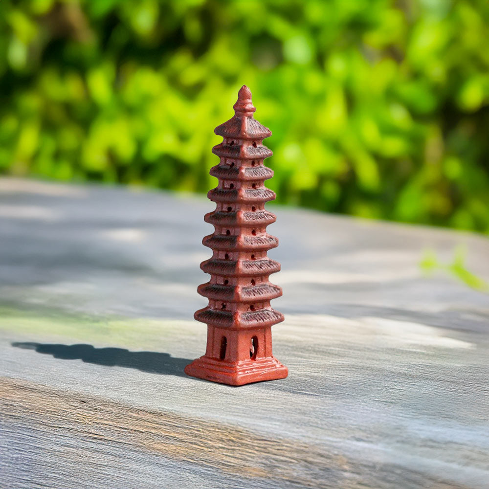 A miniature Wenchang Pagoda, its intricate details beautifully captured, stands tall against a blurred green background, bringing a touch of ancient wisdom to your miniature world.