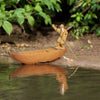 A ceramic figurine of an old fisherman rowing a wooden boat, depicting a serene maritime scene.