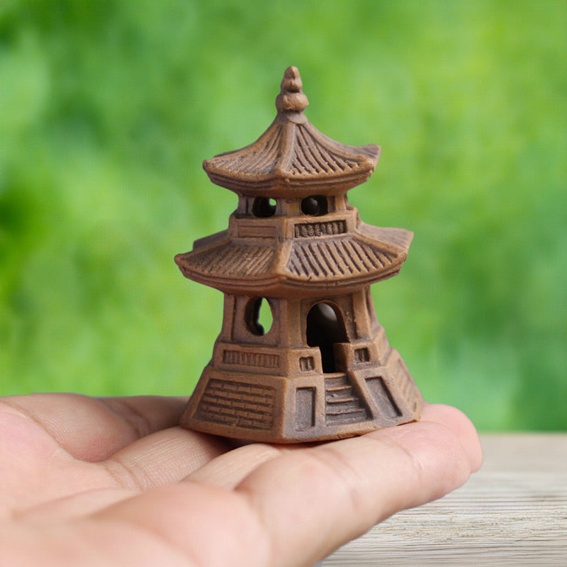 A meticulously handcrafted ceramic pagoda, small enough to fit in the palm of your hand, reveals its intricate details upon closer inspection, a testament to the artistry of Vietnamese craftsmanship.