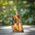 Flute Player Mudmen Figurine Ceramic Sitting Pose on a wooden surface with a blurred green background