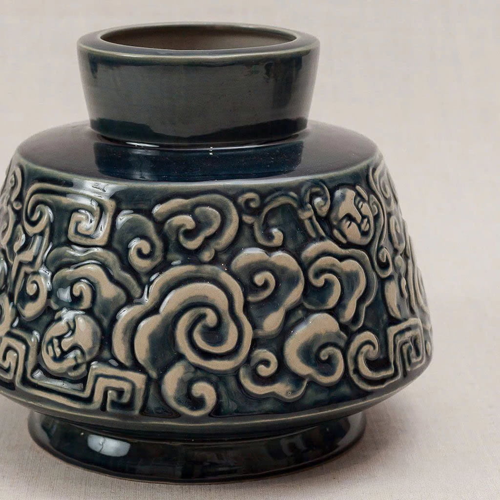  Close-up of a blue ash glaze vase. The raised cloud motif shows its artisan quality.