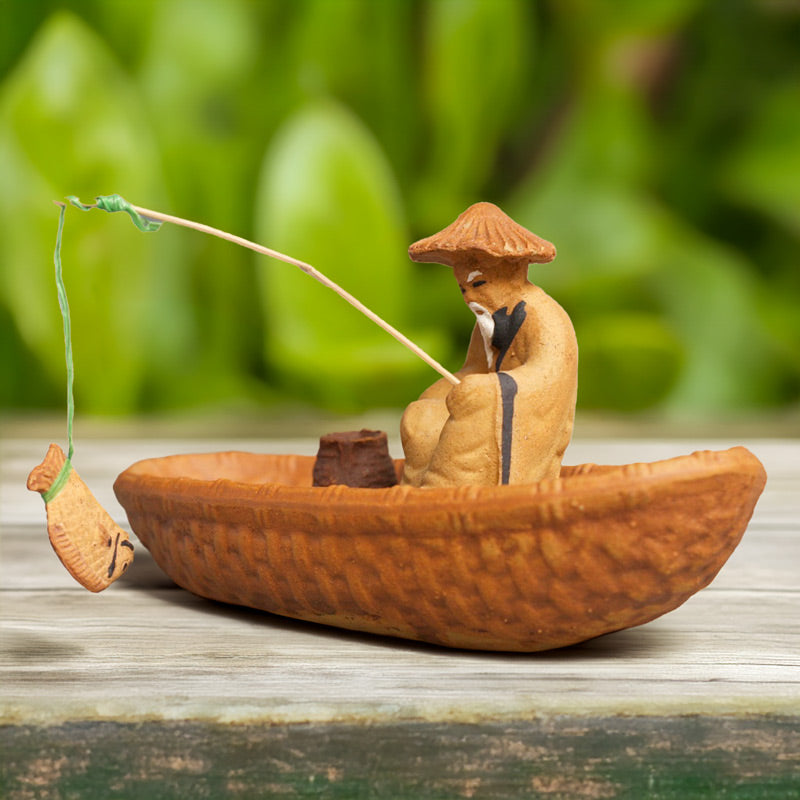 This miniature Vietnamese fisherman figurine, patiently waiting for a catch, brings a touch of Zen to any bonsai or zen garden.