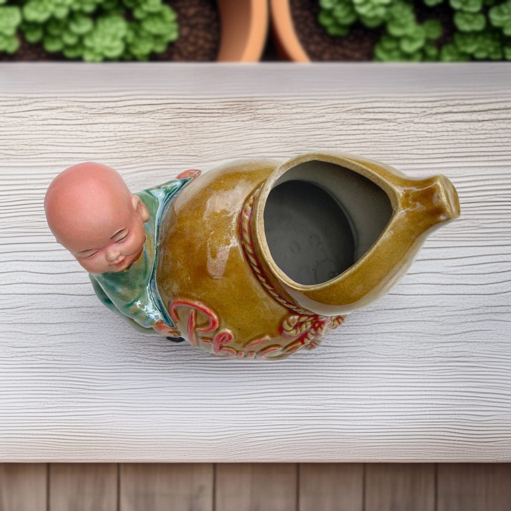 Top view of the ceramic figurine pot. A monk figurine is attached to the gourd-shaped pot