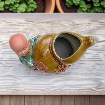 Top view of the ceramic figurine pot. A monk figurine is attached to the gourd-shaped pot