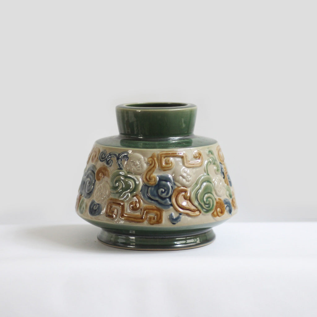 This green Vietnamese ceramic vase is a perfect centerpiece vase for a dining table. 