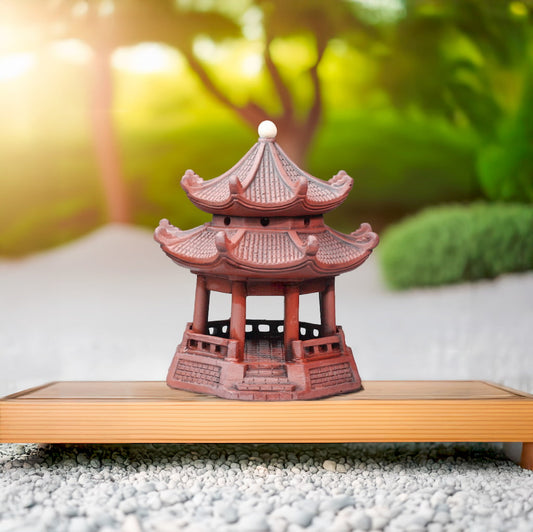 Reddish-brown octagonal miniature pagoda on wood. Ideal Zen garden decor, bonsai decor.