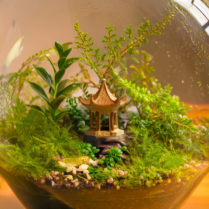 Nestled amongst lush greenery inside a glass terrarium, a miniature Vietnamese pagoda stands as a beacon of peace and harmony, creating a tiny world of tranquility.