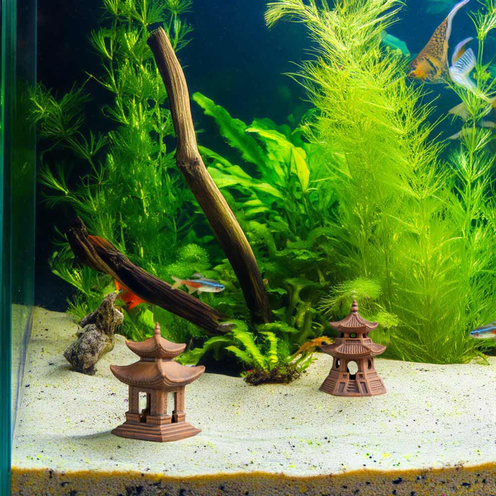 Two reddish-brown Japanese pagoda statues sit at the bottom of a fish tank with white sand, surrounded by green plants and small fish.
Từ khoá đã dùng