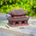  Large size miniature pagoda statue. The reddish-brown Vietnamese pagoda on a wood surface.