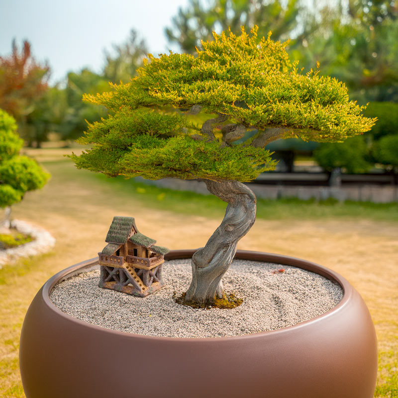 A whimsical ceramic treehouse nestled beneath a majestic bonsai tree creates a unique and enchanting scene, adding a touch of artistry to any bonsai display.