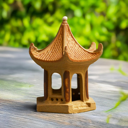 Hand-sculpted from natural clay, a miniature Vietnamese pagoda with its distinctive tiered roof and intricate details, embodies the timeless beauty of traditional Vietnamese architecture.