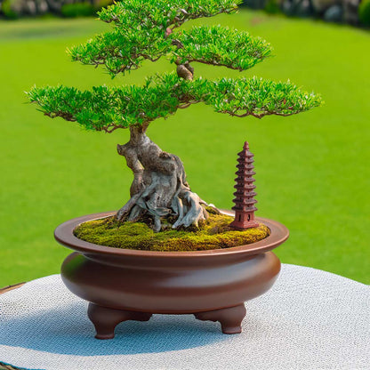 A miniature Wenchang Tower, crafted from terracotta clay, stands proudly beside a lush bonsai tree, creating a sense of harmony and balance in this miniature landscape.