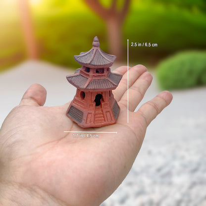 Hand holding small round miniature pagoda for bonsai. One of our bonsai figurines.